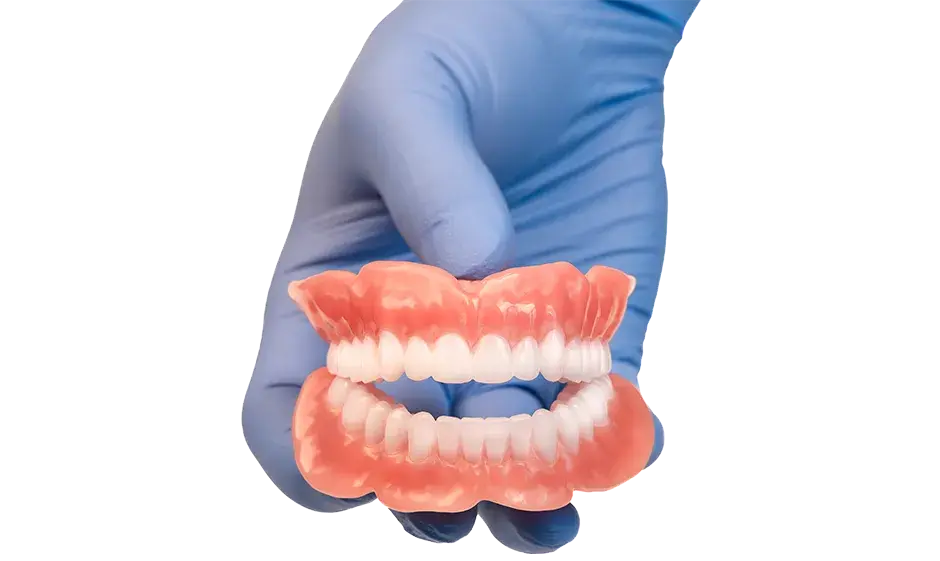 A monolithic multi-material denture produced by the NextDent 300 MultiJet printer held in a hand