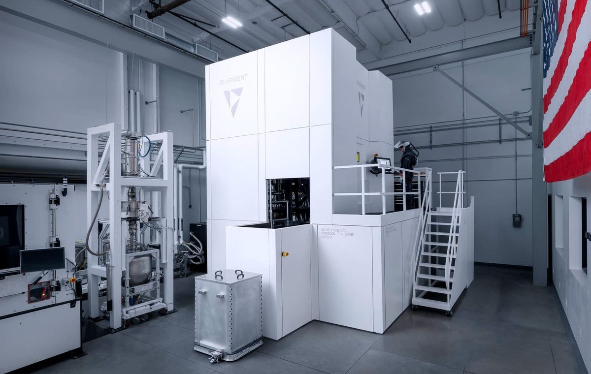 The Monolith One inside Divergent's Torrance headquarters - an 8-meter-tall, 12-laser LPBF system purpose-built for continuous production, not prototyping