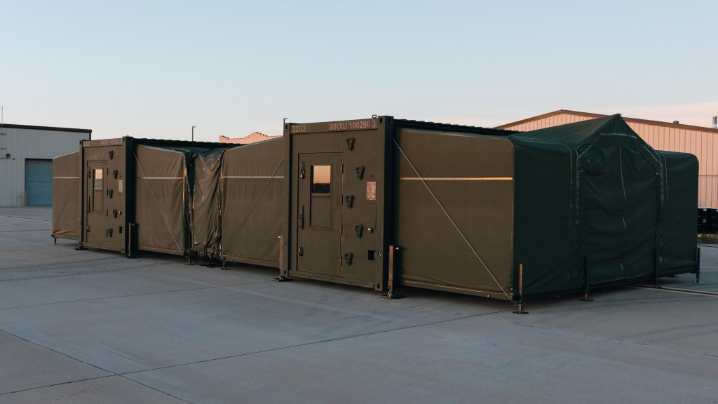 Firestorm Labs' xCell containerized manufacturing platform deployed in a field environment, housing an industrial HP Multi Jet Fusion 3D printer for on-demand drone production