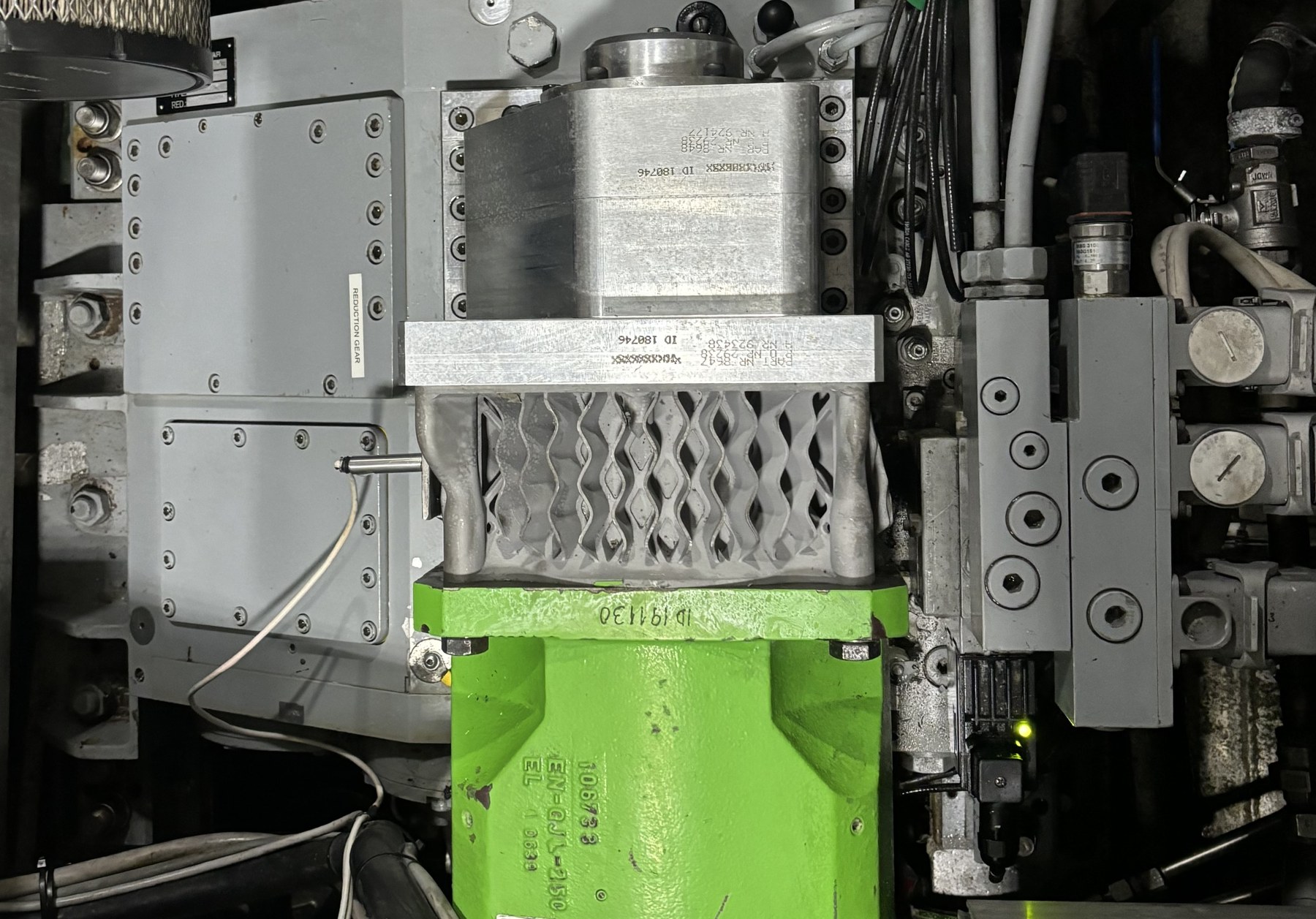 The redesigned motor cooling flange with integrated lattice cooling fins, installed on an electric motor in the system